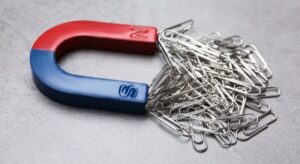 A magnet and metal paper clips being used as part of an early years STEM activity at nursery